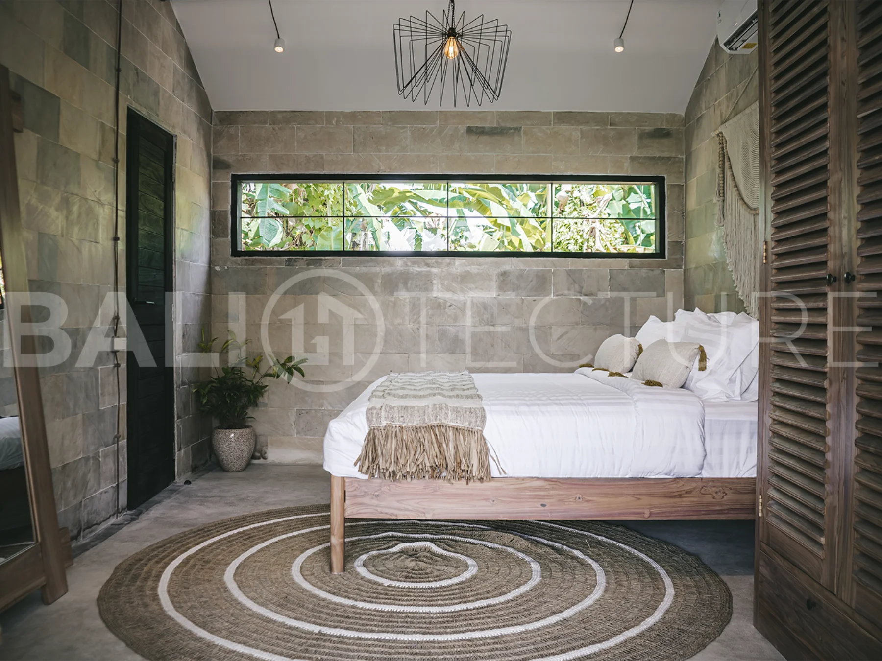 Comfortable bedroom with modern furnishings in a 4-bedroom Ubud villa.