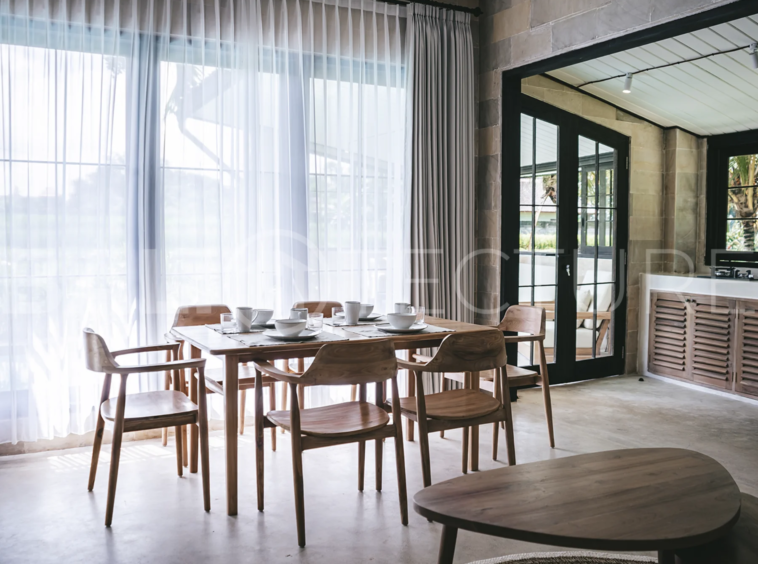 Spacious living area with stylish interiors and natural light in a luxury Ubud villa.