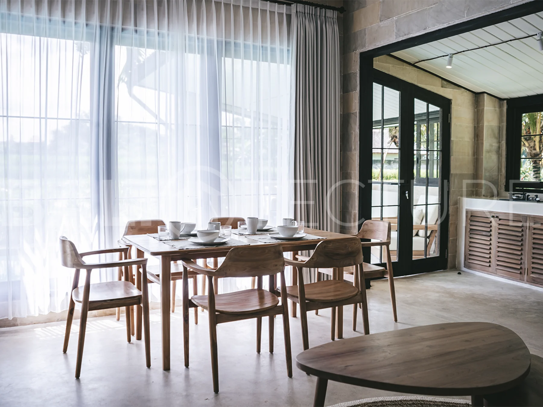 Spacious living area with stylish interiors and natural light in a luxury Ubud villa.