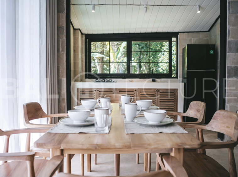 Spacious living area with stylish interiors and natural light in a luxury Ubud villa.