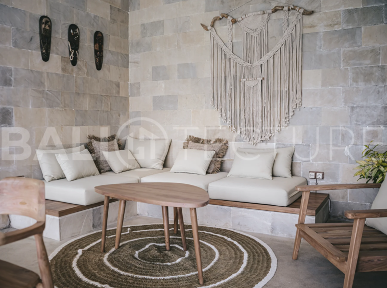 Spacious living area with stylish interiors and natural light in a luxury Ubud villa.