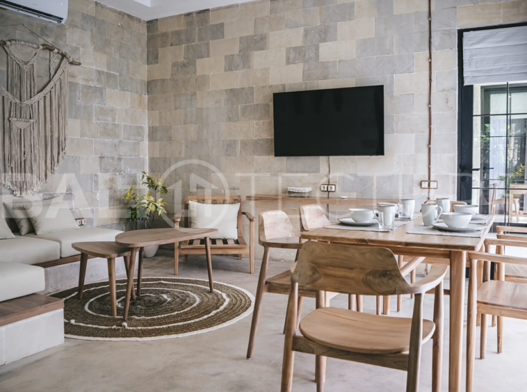 Spacious living area with stylish interiors and natural light in a luxury Ubud villa.