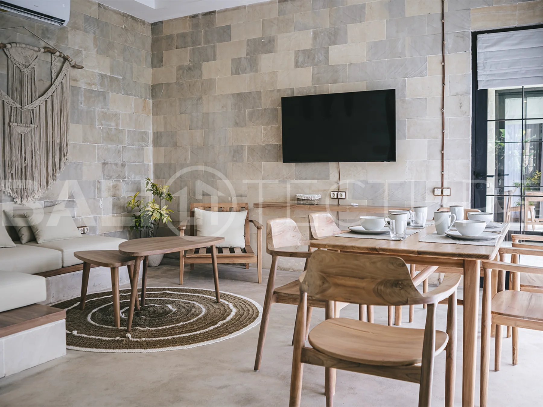 Spacious living area with stylish interiors and natural light in a luxury Ubud villa.