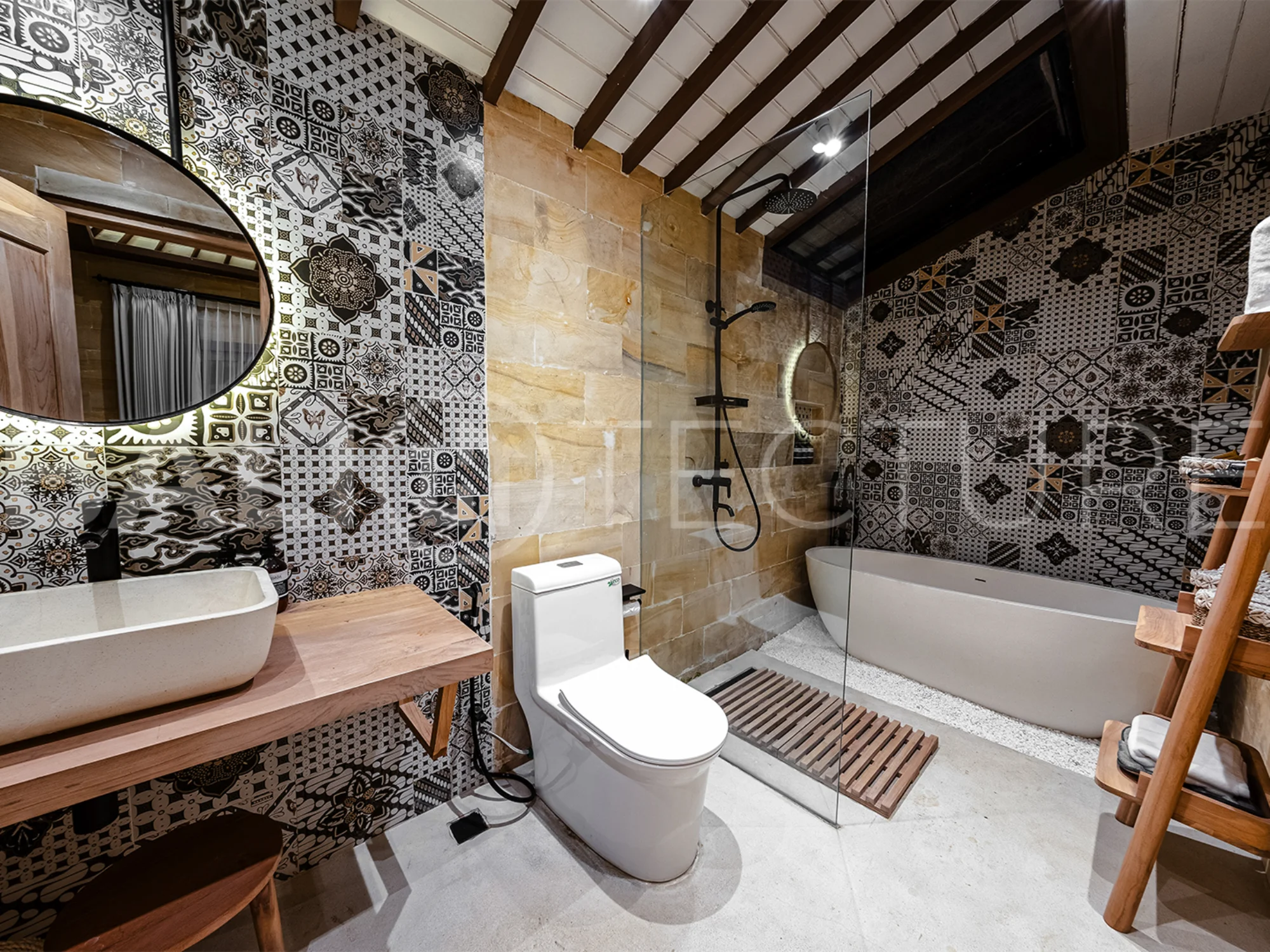 A cozy bedroom in a contemporary Ubud villa, offering comfort and views of lush tropical surroundings.