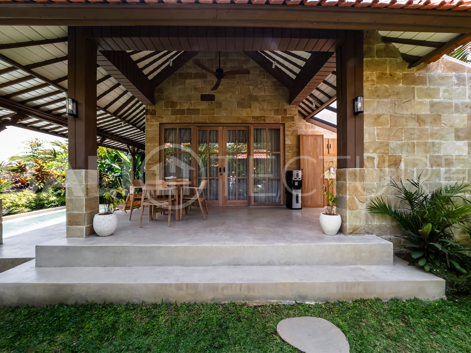A cozy bedroom in a contemporary Ubud villa, offering comfort and views of lush tropical surroundings.