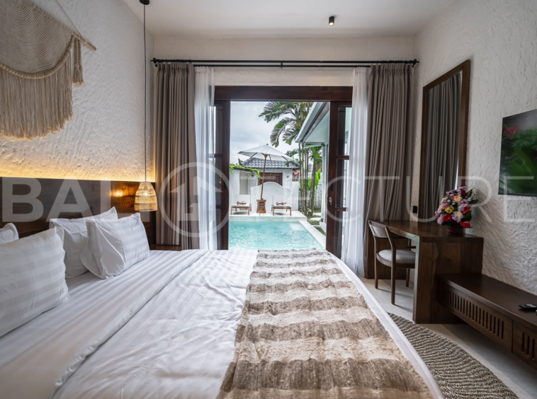 Modern villa with a private pool in Ubud, Bali, featuring sleek architecture and lush surroundings.