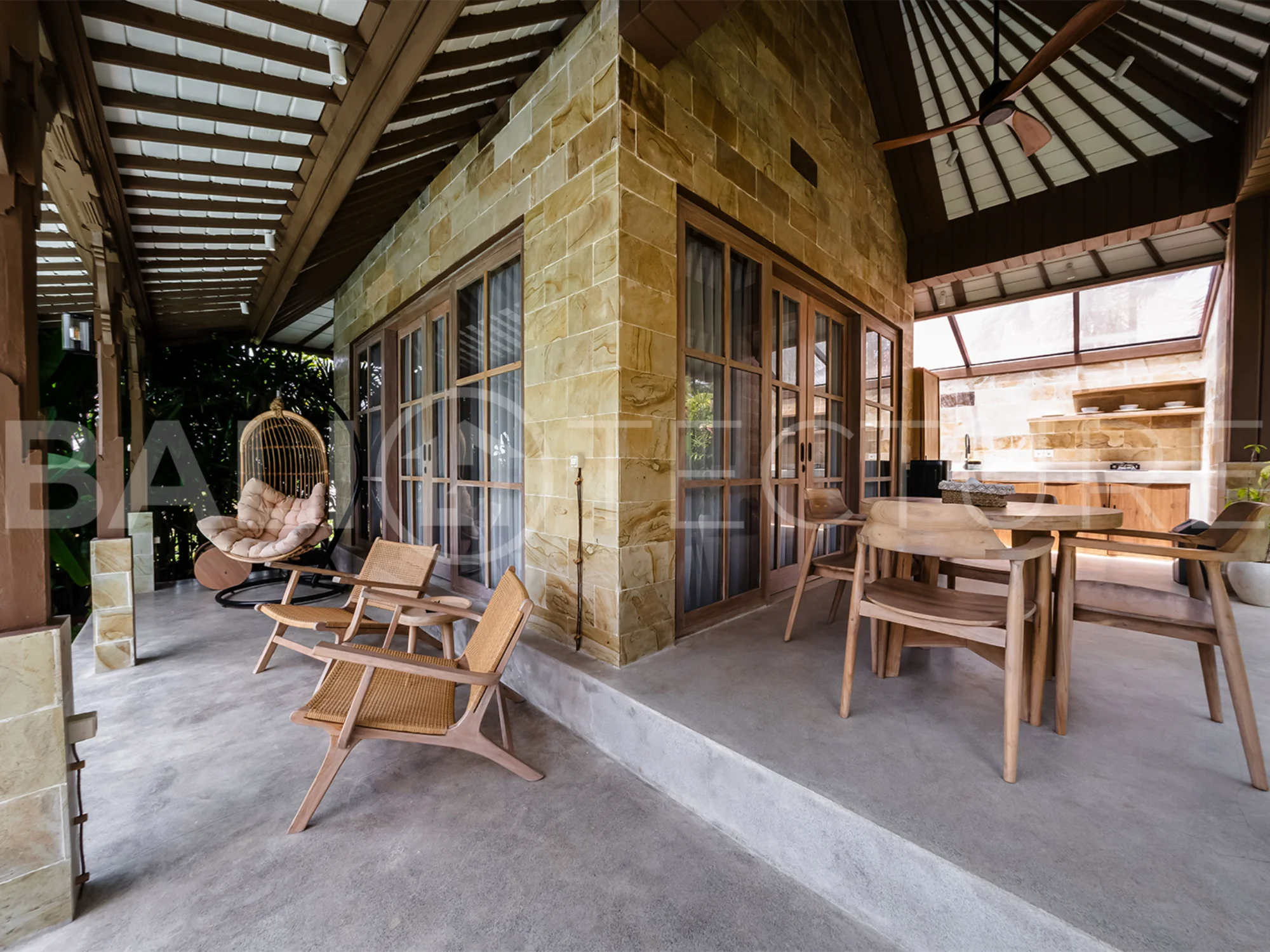A cozy bedroom in a contemporary Ubud villa, offering comfort and views of lush tropical surroundings.
