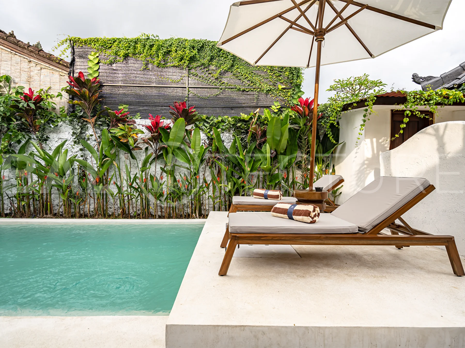 Modern villa with a private pool in Ubud, Bali, featuring sleek architecture and lush surroundings.