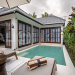 Modern villa with a private pool in Ubud, Bali, featuring sleek architecture and lush surroundings.