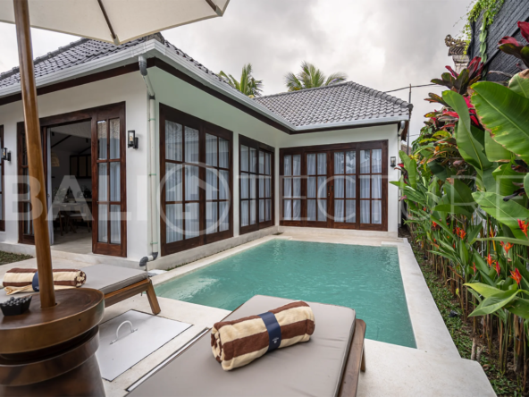 Modern villa with a private pool in Ubud, Bali, featuring sleek architecture and lush surroundings.