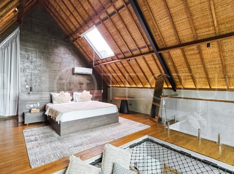 Luxury tropical-style 1-bedroom villa near Tanah Lot, Bali, featuring a two-story design with an open-plan living area, fully equipped kitchen, floor-to-ceiling glass windows, private swimming pool, river views, and lush tropical surroundings. The ensuite bedroom includes a private balcony overlooking the pool. Fully furnished and managed for rental income, this leasehold investment property is conveniently located near Tanah Lot Temple, Luna Beach Club, Nuanu City, beaches, restaurants, and cafés.