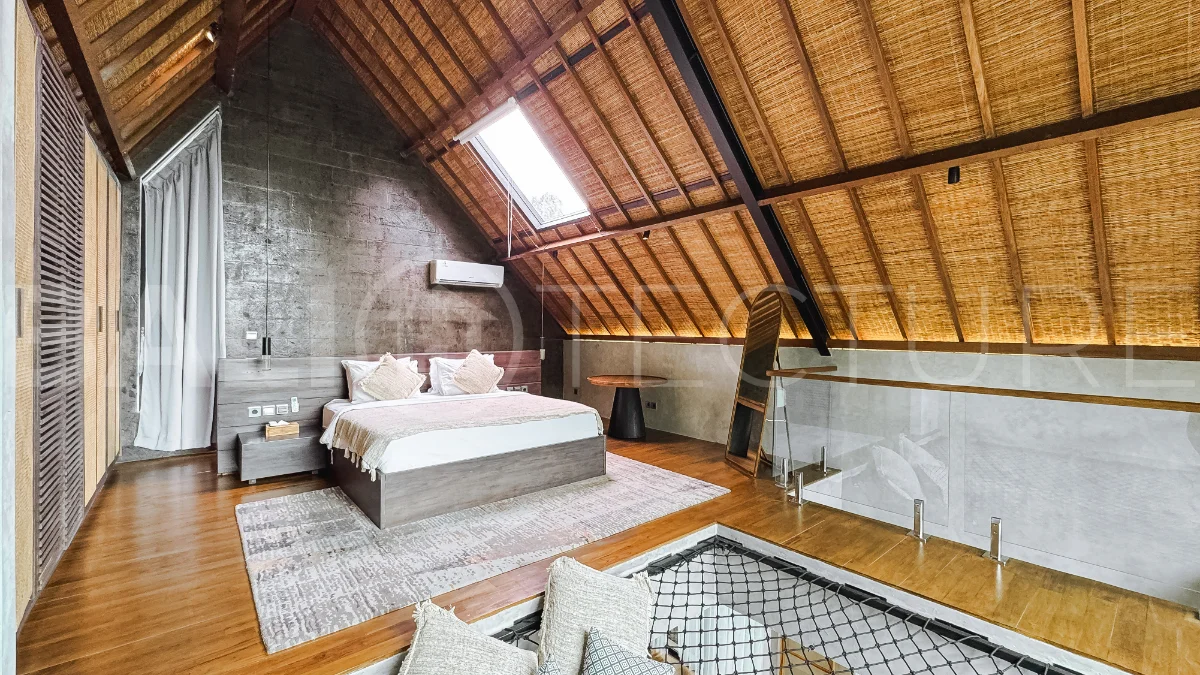 Luxury tropical-style 1-bedroom villa near Tanah Lot, Bali, featuring a two-story design with an open-plan living area, fully equipped kitchen, floor-to-ceiling glass windows, private swimming pool, river views, and lush tropical surroundings. The ensuite bedroom includes a private balcony overlooking the pool. Fully furnished and managed for rental income, this leasehold investment property is conveniently located near Tanah Lot Temple, Luna Beach Club, Nuanu City, beaches, restaurants, and cafés.