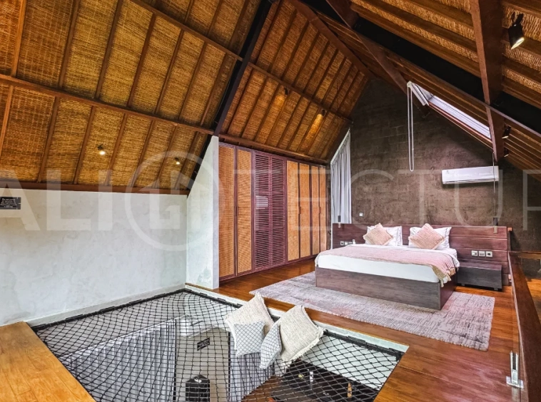 Luxury tropical-style 1-bedroom villa near Tanah Lot, Bali, featuring a two-story design with an open-plan living area, fully equipped kitchen, floor-to-ceiling glass windows, private swimming pool, river views, and lush tropical surroundings. The ensuite bedroom includes a private balcony overlooking the pool. Fully furnished and managed for rental income, this leasehold investment property is conveniently located near Tanah Lot Temple, Luna Beach Club, Nuanu City, beaches, restaurants, and cafés.
