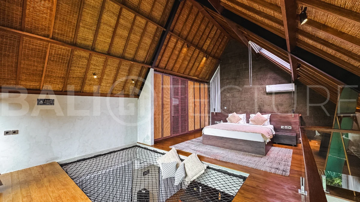 Luxury tropical-style 1-bedroom villa near Tanah Lot, Bali, featuring a two-story design with an open-plan living area, fully equipped kitchen, floor-to-ceiling glass windows, private swimming pool, river views, and lush tropical surroundings. The ensuite bedroom includes a private balcony overlooking the pool. Fully furnished and managed for rental income, this leasehold investment property is conveniently located near Tanah Lot Temple, Luna Beach Club, Nuanu City, beaches, restaurants, and cafés.