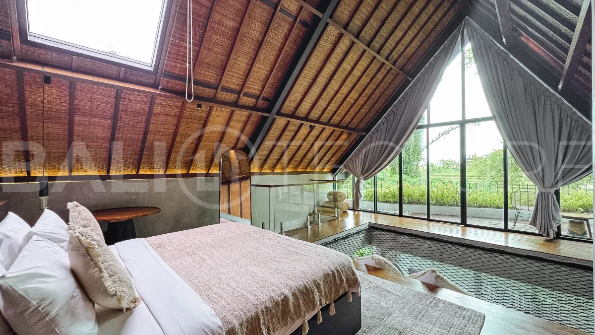 Luxury tropical-style 1-bedroom villa near Tanah Lot, Bali, featuring a two-story design with an open-plan living area, fully equipped kitchen, floor-to-ceiling glass windows, private swimming pool, river views, and lush tropical surroundings. The ensuite bedroom includes a private balcony overlooking the pool. Fully furnished and managed for rental income, this leasehold investment property is conveniently located near Tanah Lot Temple, Luna Beach Club, Nuanu City, beaches, restaurants, and cafés.