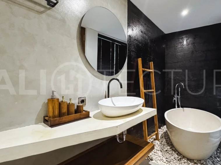 Luxury tropical-style 1-bedroom villa near Tanah Lot, Bali, featuring a two-story design with an open-plan living area, fully equipped kitchen, floor-to-ceiling glass windows, private swimming pool, river views, and lush tropical surroundings. The ensuite bedroom includes a private balcony overlooking the pool. Fully furnished and managed for rental income, this leasehold investment property is conveniently located near Tanah Lot Temple, Luna Beach Club, Nuanu City, beaches, restaurants, and cafés.