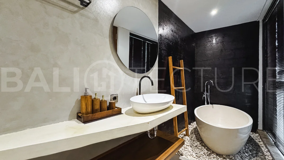 Luxury tropical-style 1-bedroom villa near Tanah Lot, Bali, featuring a two-story design with an open-plan living area, fully equipped kitchen, floor-to-ceiling glass windows, private swimming pool, river views, and lush tropical surroundings. The ensuite bedroom includes a private balcony overlooking the pool. Fully furnished and managed for rental income, this leasehold investment property is conveniently located near Tanah Lot Temple, Luna Beach Club, Nuanu City, beaches, restaurants, and cafés.