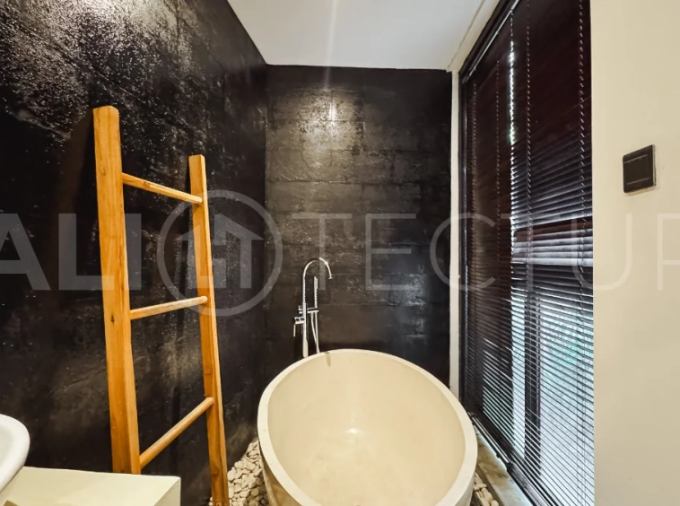 Luxury tropical-style 1-bedroom villa near Tanah Lot, Bali, featuring a two-story design with an open-plan living area, fully equipped kitchen, floor-to-ceiling glass windows, private swimming pool, river views, and lush tropical surroundings. The ensuite bedroom includes a private balcony overlooking the pool. Fully furnished and managed for rental income, this leasehold investment property is conveniently located near Tanah Lot Temple, Luna Beach Club, Nuanu City, beaches, restaurants, and cafés.