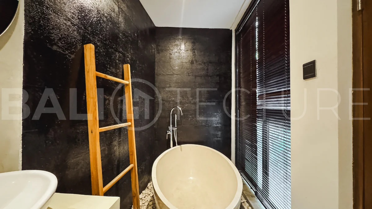 Luxury tropical-style 1-bedroom villa near Tanah Lot, Bali, featuring a two-story design with an open-plan living area, fully equipped kitchen, floor-to-ceiling glass windows, private swimming pool, river views, and lush tropical surroundings. The ensuite bedroom includes a private balcony overlooking the pool. Fully furnished and managed for rental income, this leasehold investment property is conveniently located near Tanah Lot Temple, Luna Beach Club, Nuanu City, beaches, restaurants, and cafés.