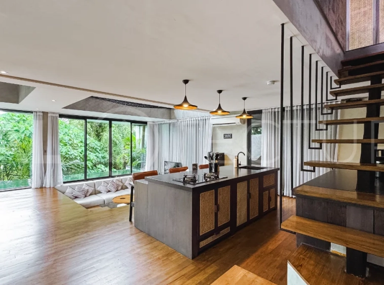 Luxury tropical-style 1-bedroom villa near Tanah Lot, Bali, featuring a two-story design with an open-plan living area, fully equipped kitchen, floor-to-ceiling glass windows, private swimming pool, river views, and lush tropical surroundings. The ensuite bedroom includes a private balcony overlooking the pool. Fully furnished and managed for rental income, this leasehold investment property is conveniently located near Tanah Lot Temple, Luna Beach Club, Nuanu City, beaches, restaurants, and cafés.