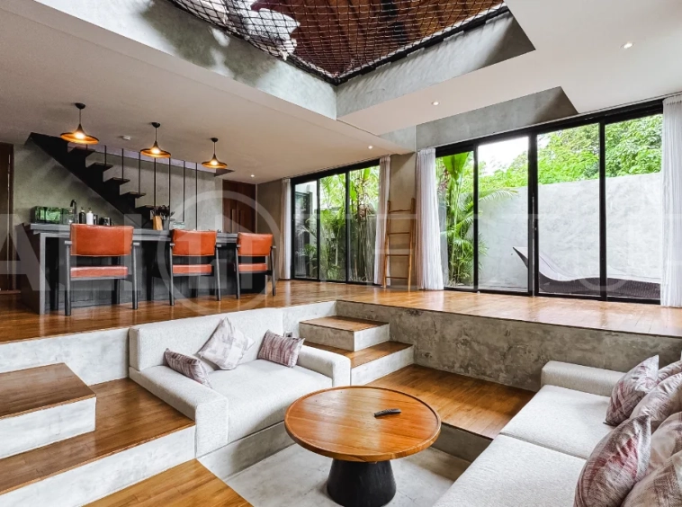 Luxury tropical-style 1-bedroom villa near Tanah Lot, Bali, featuring a two-story design with an open-plan living area, fully equipped kitchen, floor-to-ceiling glass windows, private swimming pool, river views, and lush tropical surroundings. The ensuite bedroom includes a private balcony overlooking the pool. Fully furnished and managed for rental income, this leasehold investment property is conveniently located near Tanah Lot Temple, Luna Beach Club, Nuanu City, beaches, restaurants, and cafés.