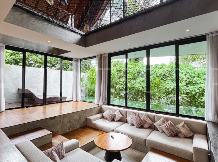 Luxury tropical-style 1-bedroom villa near Tanah Lot, Bali, featuring a two-story design with an open-plan living area, fully equipped kitchen, floor-to-ceiling glass windows, private swimming pool, river views, and lush tropical surroundings. The ensuite bedroom includes a private balcony overlooking the pool. Fully furnished and managed for rental income, this leasehold investment property is conveniently located near Tanah Lot Temple, Luna Beach Club, Nuanu City, beaches, restaurants, and cafés.