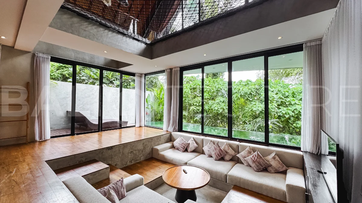 Luxury tropical-style 1-bedroom villa near Tanah Lot, Bali, featuring a two-story design with an open-plan living area, fully equipped kitchen, floor-to-ceiling glass windows, private swimming pool, river views, and lush tropical surroundings. The ensuite bedroom includes a private balcony overlooking the pool. Fully furnished and managed for rental income, this leasehold investment property is conveniently located near Tanah Lot Temple, Luna Beach Club, Nuanu City, beaches, restaurants, and cafés.
