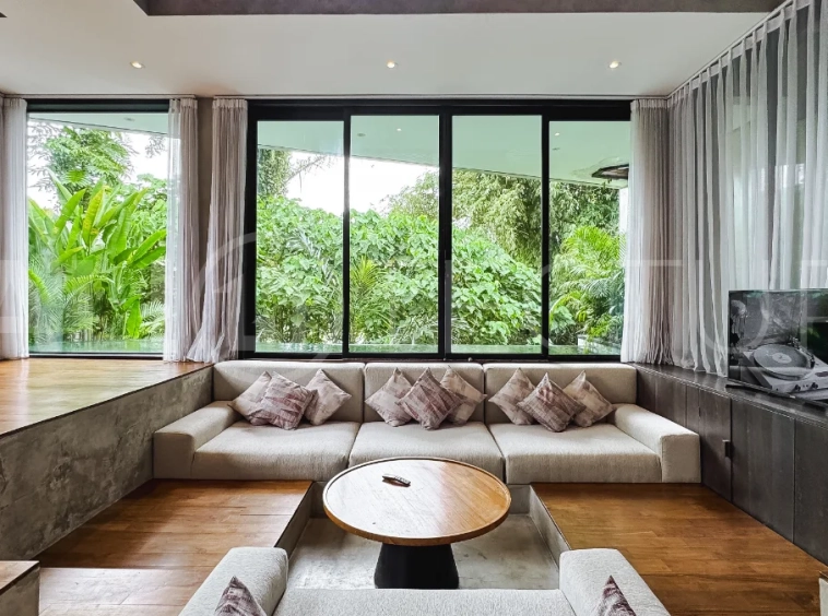 Luxury tropical-style 1-bedroom villa near Tanah Lot, Bali, featuring a two-story design with an open-plan living area, fully equipped kitchen, floor-to-ceiling glass windows, private swimming pool, river views, and lush tropical surroundings. The ensuite bedroom includes a private balcony overlooking the pool. Fully furnished and managed for rental income, this leasehold investment property is conveniently located near Tanah Lot Temple, Luna Beach Club, Nuanu City, beaches, restaurants, and cafés.