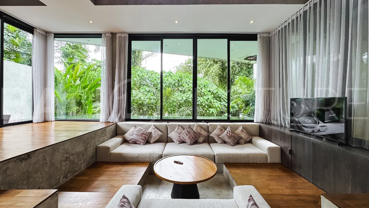 Luxury tropical-style 1-bedroom villa near Tanah Lot, Bali, featuring a two-story design with an open-plan living area, fully equipped kitchen, floor-to-ceiling glass windows, private swimming pool, river views, and lush tropical surroundings. The ensuite bedroom includes a private balcony overlooking the pool. Fully furnished and managed for rental income, this leasehold investment property is conveniently located near Tanah Lot Temple, Luna Beach Club, Nuanu City, beaches, restaurants, and cafés.