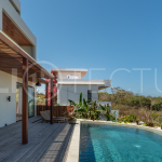 Luxury 3-bedroom ocean-view villa in Pecatu, Uluwatu, Bali, featuring a private pool, tropical Zen garden, rooftop terrace, modern interiors, and panoramic sunset views.