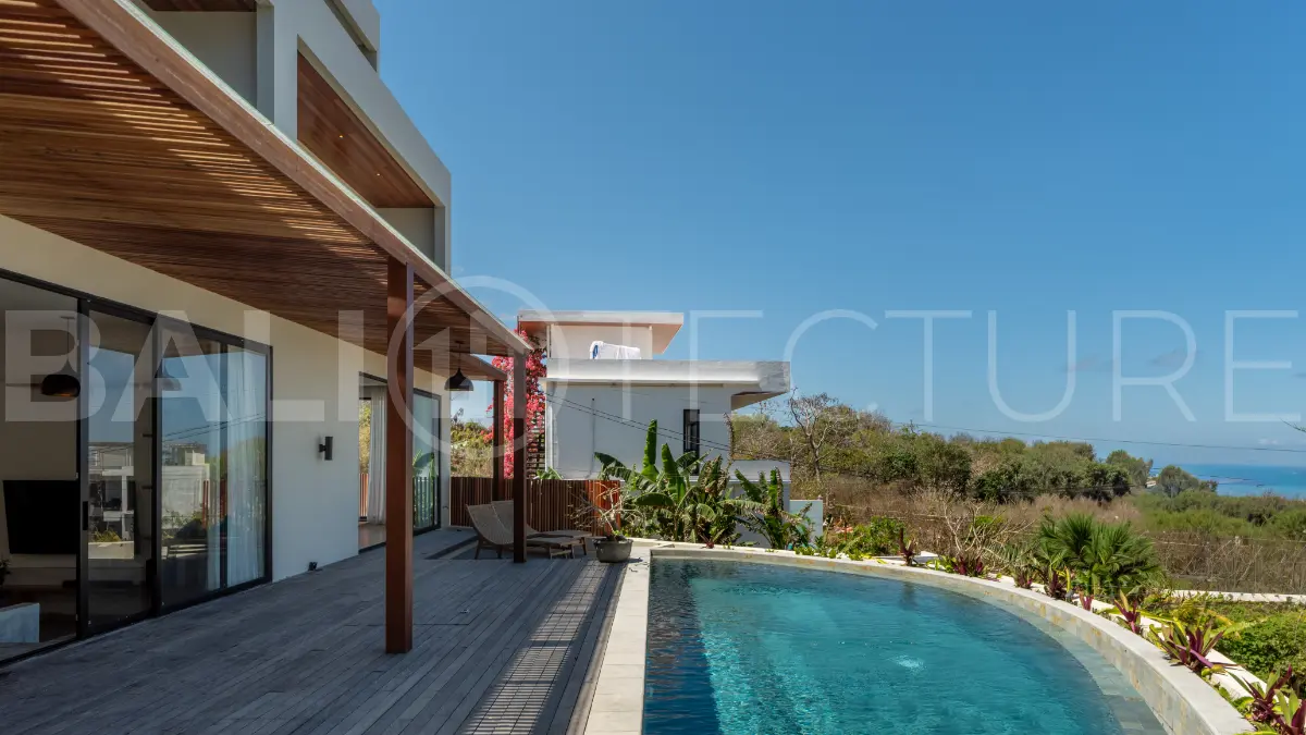 Luxury 3-bedroom ocean-view villa in Pecatu, Uluwatu, Bali, featuring a private pool, tropical Zen garden, rooftop terrace, modern interiors, and panoramic sunset views.