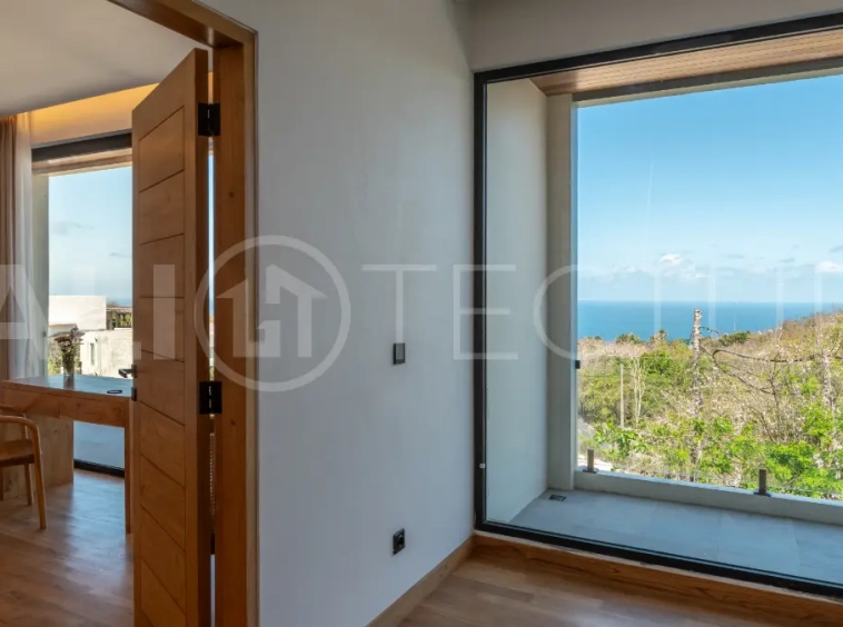 Luxury 3-bedroom ocean-view villa in Pecatu, Uluwatu, Bali, featuring a private pool, tropical Zen garden, rooftop terrace, modern interiors, and panoramic sunset views.
