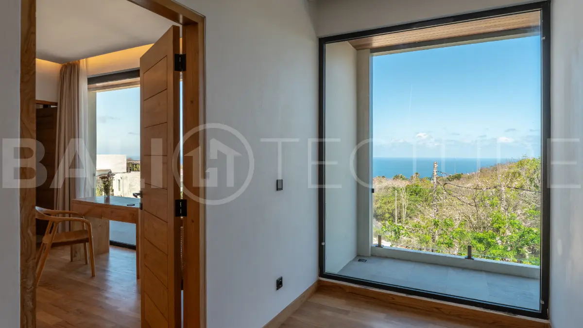 Luxury 3-bedroom ocean-view villa in Pecatu, Uluwatu, Bali, featuring a private pool, tropical Zen garden, rooftop terrace, modern interiors, and panoramic sunset views.