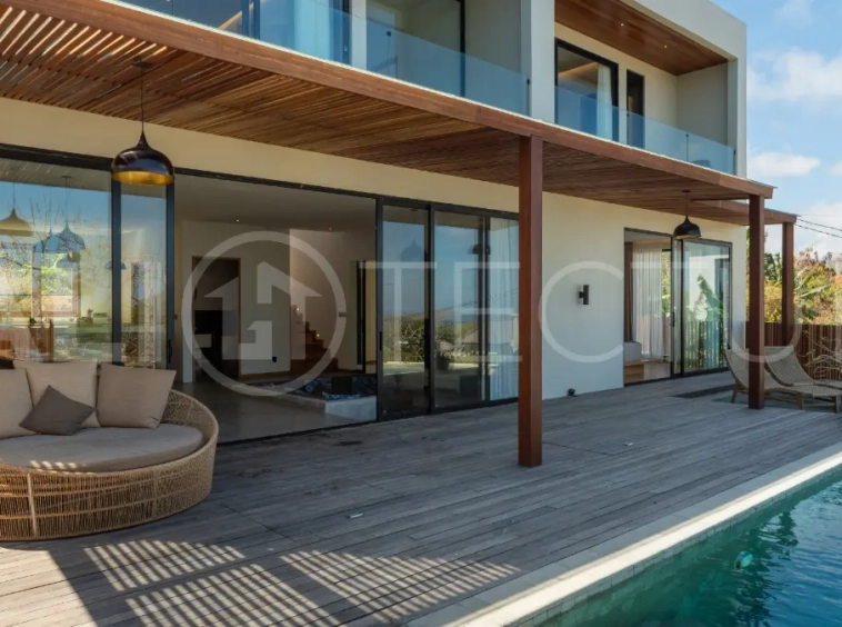 Luxury 3-bedroom ocean-view villa in Pecatu, Uluwatu, Bali, featuring a private pool, tropical Zen garden, rooftop terrace, modern interiors, and panoramic sunset views.