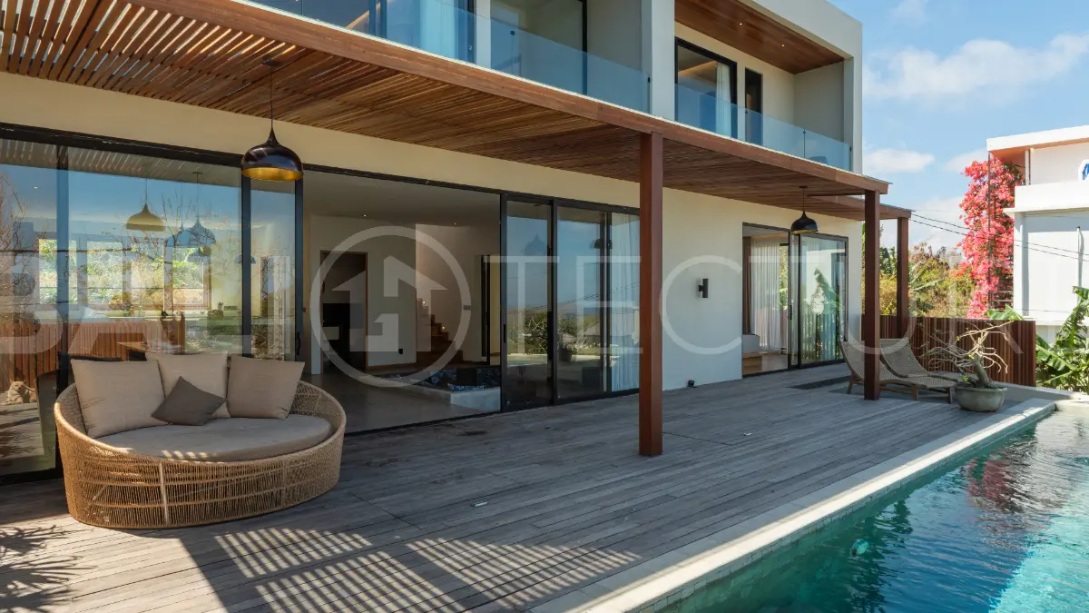 Luxury 3-bedroom ocean-view villa in Pecatu, Uluwatu, Bali, featuring a private pool, tropical Zen garden, rooftop terrace, modern interiors, and panoramic sunset views.