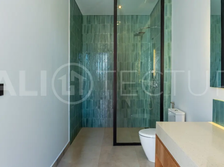 Luxury 3-bedroom ocean-view villa in Pecatu, Uluwatu, Bali, featuring a private pool, tropical Zen garden, rooftop terrace, modern interiors, and panoramic sunset views.