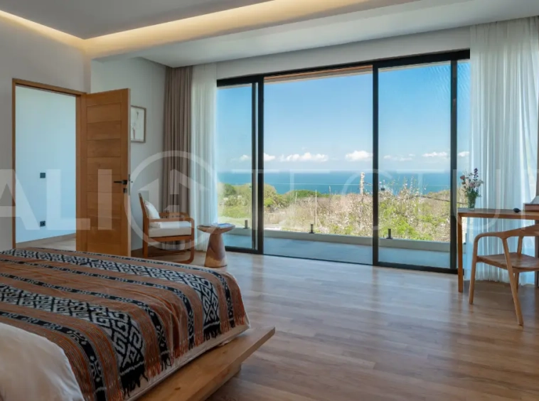 Luxury 3-bedroom ocean-view villa in Pecatu, Uluwatu, Bali, featuring a private pool, tropical Zen garden, rooftop terrace, modern interiors, and panoramic sunset views.