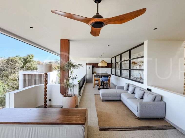 Brand new 3-bedroom tropical villa in Pecatu, Uluwatu featuring contemporary architecture, elegant natural finishes, and panoramic ocean views. The property includes three ensuite bedrooms, an enclosed living and dining area, a fully enclosed kitchen, a private 6 x 2 meter swimming pool, landscaped garden, balcony, and a rooftop terrace overlooking the ocean. Set on 204 m² of land with a 220 m² two-story building, the fully furnished villa is scheduled for completion in 2026 and is available under freehold and leasehold ownership in a prime tourism area.