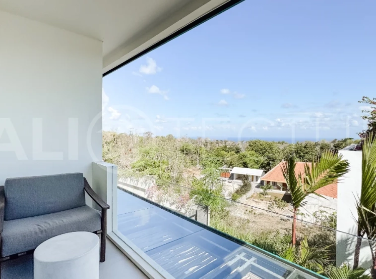 Brand new 3-bedroom tropical villa in Pecatu, Uluwatu featuring contemporary architecture, elegant natural finishes, and panoramic ocean views. The property includes three ensuite bedrooms, an enclosed living and dining area, a fully enclosed kitchen, a private 6 x 2 meter swimming pool, landscaped garden, balcony, and a rooftop terrace overlooking the ocean. Set on 204 m² of land with a 220 m² two-story building, the fully furnished villa is scheduled for completion in 2026 and is available under freehold and leasehold ownership in a prime tourism area.
