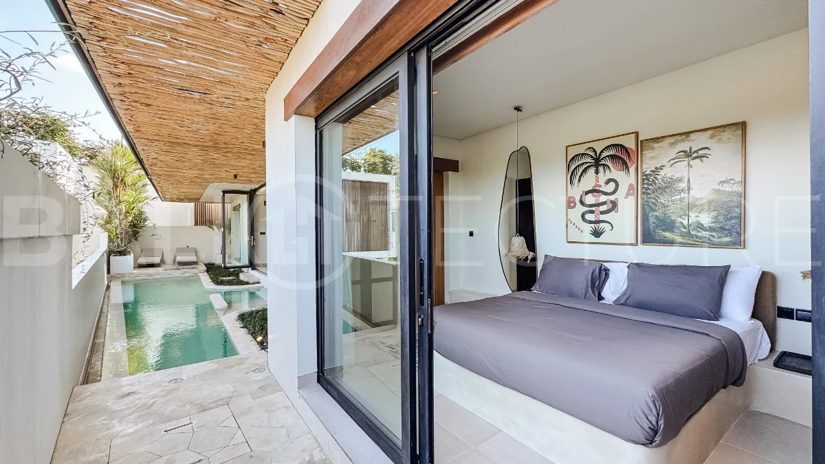 Brand new 3-bedroom tropical villa in Pecatu, Uluwatu featuring contemporary architecture, elegant natural finishes, and panoramic ocean views. The property includes three ensuite bedrooms, an enclosed living and dining area, a fully enclosed kitchen, a private 6 x 2 meter swimming pool, landscaped garden, balcony, and a rooftop terrace overlooking the ocean. Set on 204 m² of land with a 220 m² two-story building, the fully furnished villa is scheduled for completion in 2026 and is available under freehold and leasehold ownership in a prime tourism area.