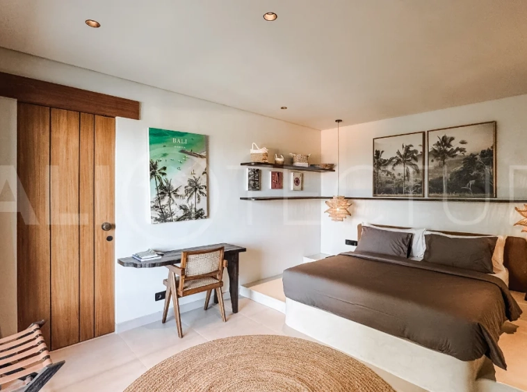 Brand new 3-bedroom tropical villa in Pecatu, Uluwatu featuring contemporary architecture, elegant natural finishes, and panoramic ocean views. The property includes three ensuite bedrooms, an enclosed living and dining area, a fully enclosed kitchen, a private 6 x 2 meter swimming pool, landscaped garden, balcony, and a rooftop terrace overlooking the ocean. Set on 204 m² of land with a 220 m² two-story building, the fully furnished villa is scheduled for completion in 2026 and is available under freehold and leasehold ownership in a prime tourism area.