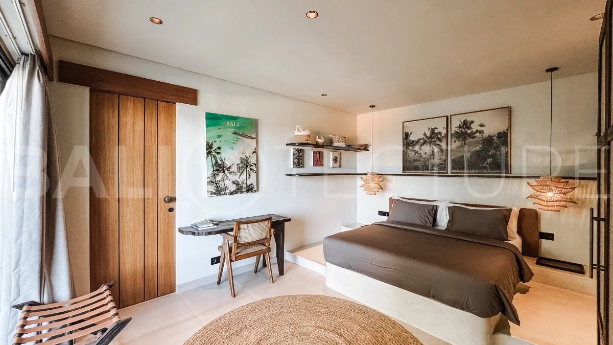 Brand new 3-bedroom tropical villa in Pecatu, Uluwatu featuring contemporary architecture, elegant natural finishes, and panoramic ocean views. The property includes three ensuite bedrooms, an enclosed living and dining area, a fully enclosed kitchen, a private 6 x 2 meter swimming pool, landscaped garden, balcony, and a rooftop terrace overlooking the ocean. Set on 204 m² of land with a 220 m² two-story building, the fully furnished villa is scheduled for completion in 2026 and is available under freehold and leasehold ownership in a prime tourism area.