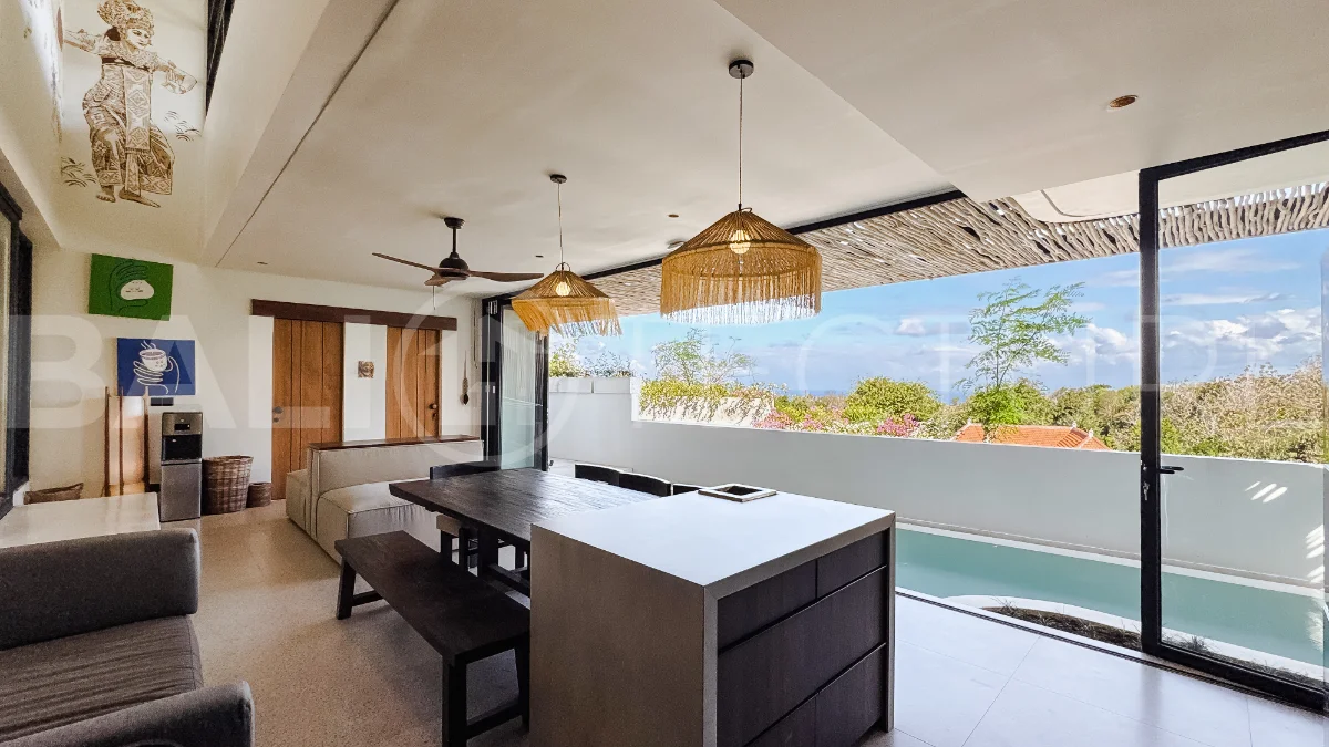 Brand new 3-bedroom tropical villa in Pecatu, Uluwatu featuring contemporary architecture, elegant natural finishes, and panoramic ocean views. The property includes three ensuite bedrooms, an enclosed living and dining area, a fully enclosed kitchen, a private 6 x 2 meter swimming pool, landscaped garden, balcony, and a rooftop terrace overlooking the ocean. Set on 204 m² of land with a 220 m² two-story building, the fully furnished villa is scheduled for completion in 2026 and is available under freehold and leasehold ownership in a prime tourism area.