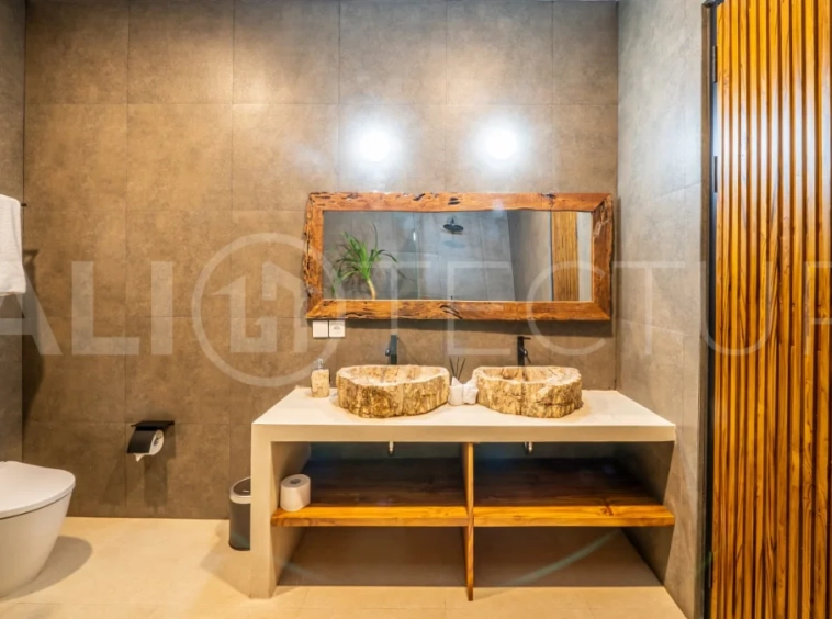 Brand-new 2-bedroom freehold villa near Pandawa Beach, featuring a modern tropical design, spacious interiors, high ceilings, large glass windows, private swimming pool, and elegant natural stone and wood finishes.