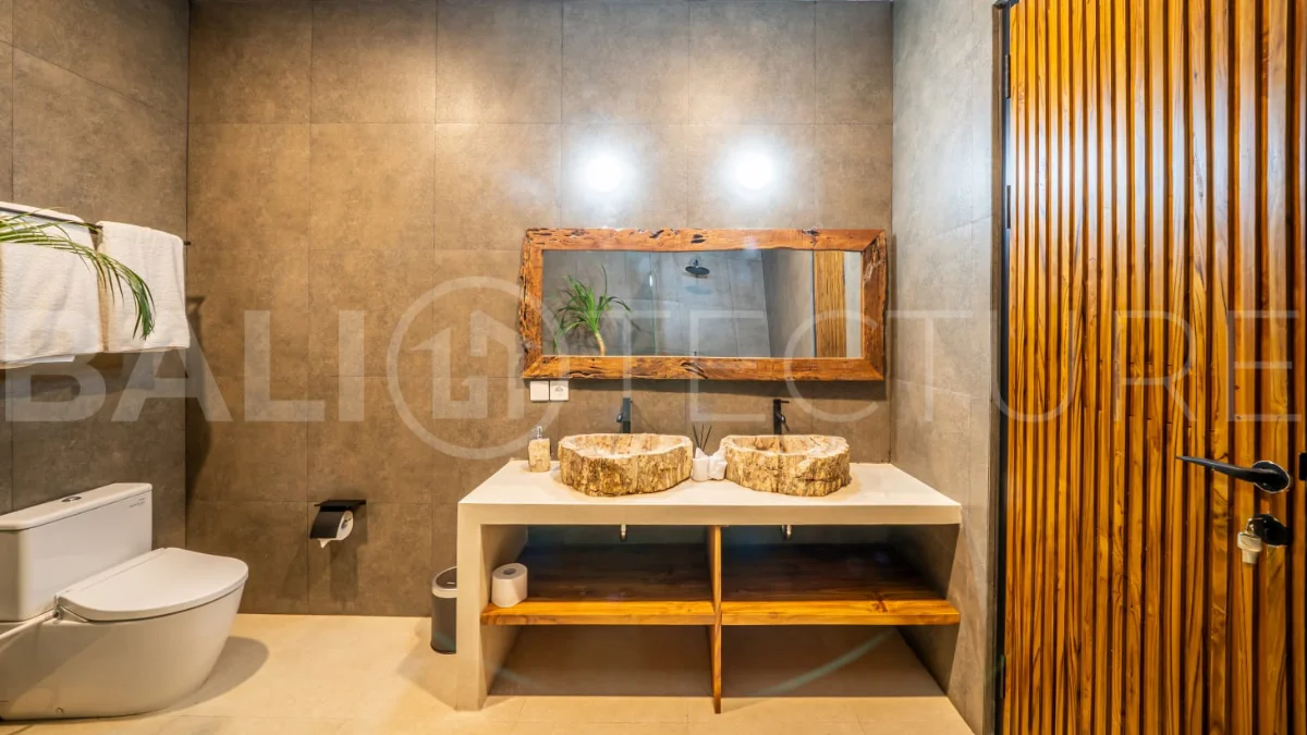 Brand-new 2-bedroom freehold villa near Pandawa Beach, featuring a modern tropical design, spacious interiors, high ceilings, large glass windows, private swimming pool, and elegant natural stone and wood finishes.