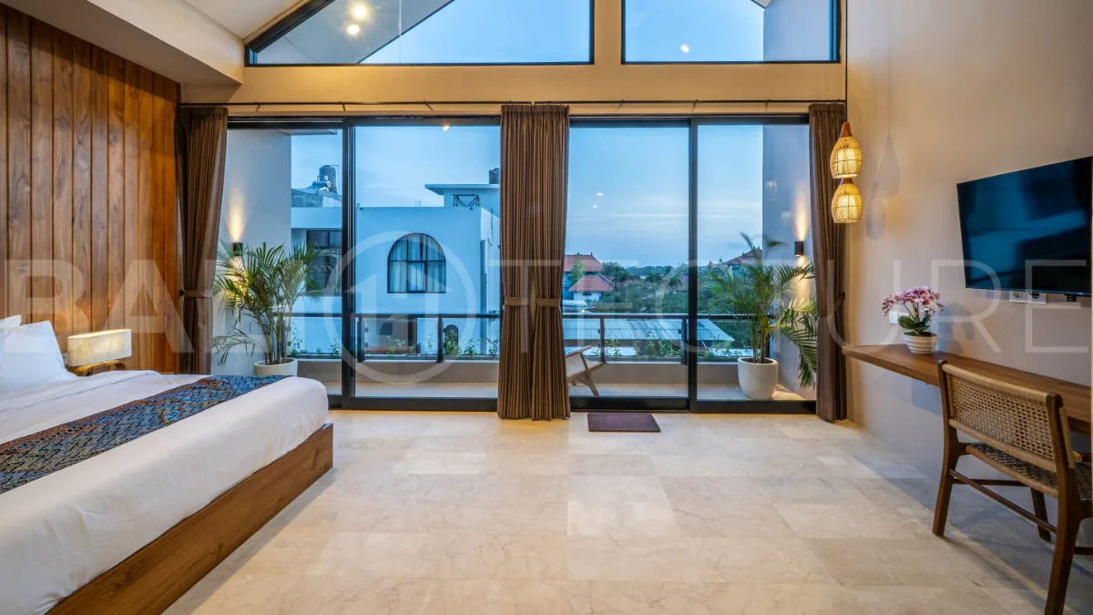 Brand-new 2-bedroom freehold villa near Pandawa Beach, featuring a modern tropical design, spacious interiors, high ceilings, large glass windows, private swimming pool, and elegant natural stone and wood finishes.