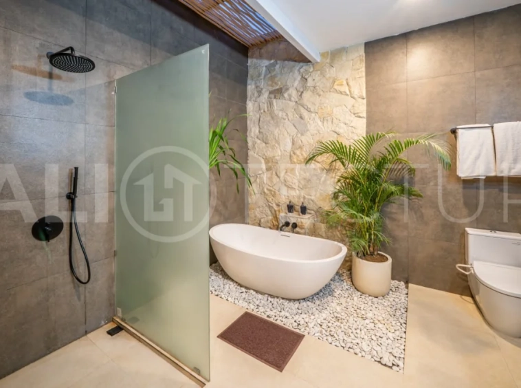 Brand-new 2-bedroom freehold villa near Pandawa Beach, featuring a modern tropical design, spacious interiors, high ceilings, large glass windows, private swimming pool, and elegant natural stone and wood finishes.