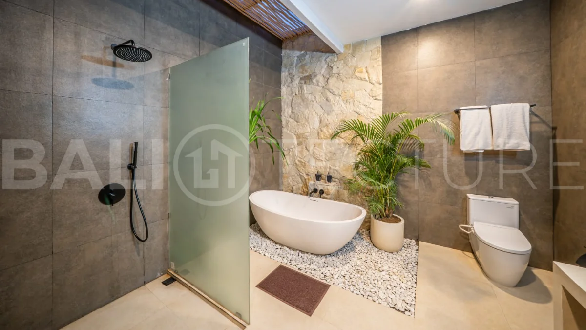 Brand-new 2-bedroom freehold villa near Pandawa Beach, featuring a modern tropical design, spacious interiors, high ceilings, large glass windows, private swimming pool, and elegant natural stone and wood finishes.