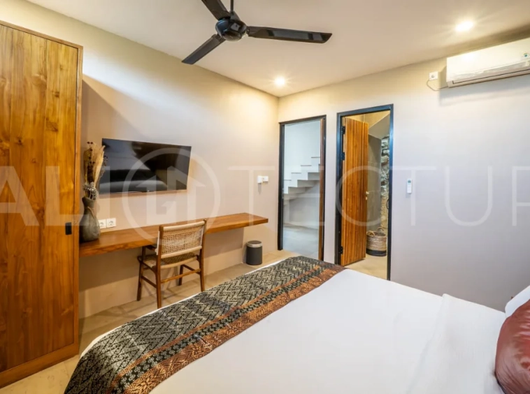 Brand-new 2-bedroom freehold villa near Pandawa Beach, featuring a modern tropical design, spacious interiors, high ceilings, large glass windows, private swimming pool, and elegant natural stone and wood finishes.