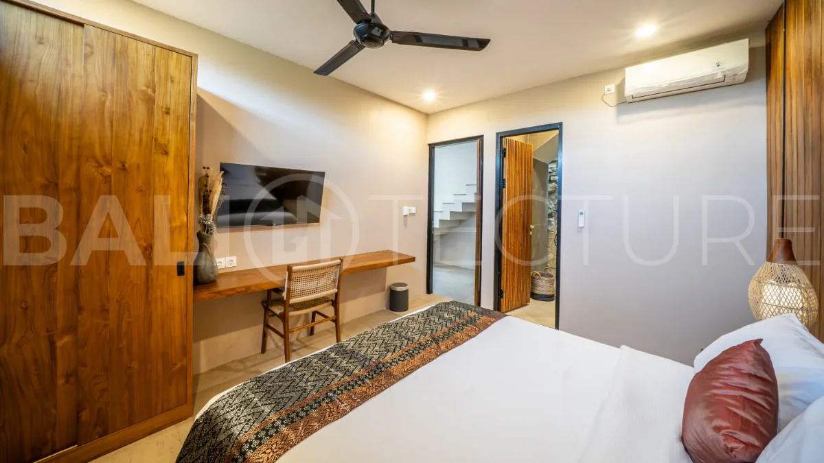 Brand-new 2-bedroom freehold villa near Pandawa Beach, featuring a modern tropical design, spacious interiors, high ceilings, large glass windows, private swimming pool, and elegant natural stone and wood finishes.